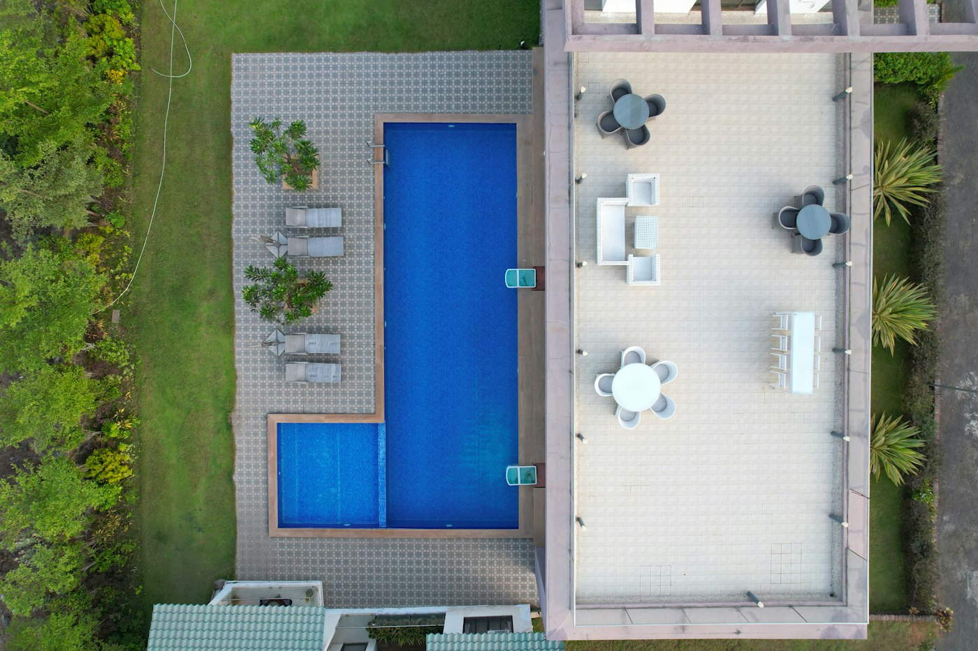 Aerial view of a rectangular pool beside a patio