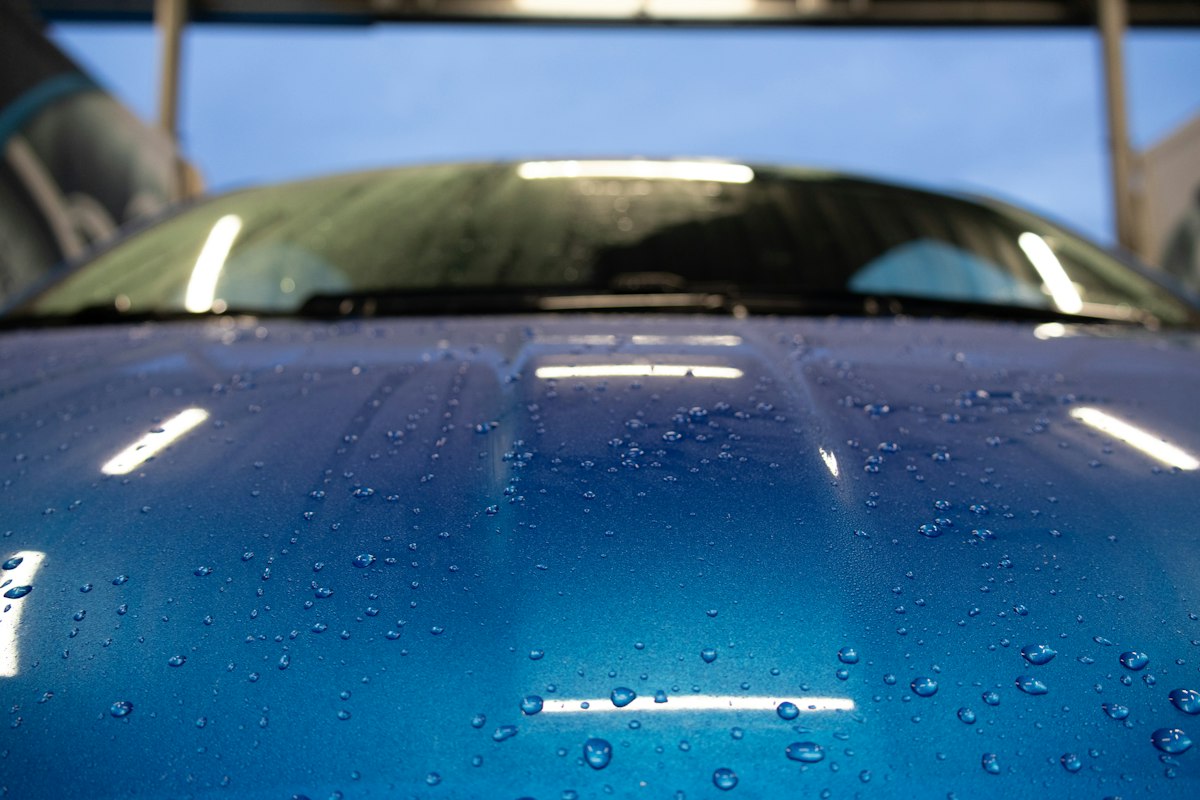 Water beading on a freshly coated blue hood